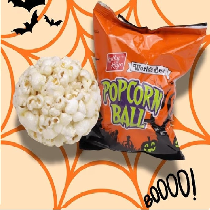 Kathy Kaye World's Best Popcorn Ball Halloween candy next to a single popcorn ball, set against a Halloween-themed background with orange spiderwebs, bats, and jack-o'-lanterns.
